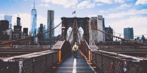 construction worker on a bridge with New York City skyline view
