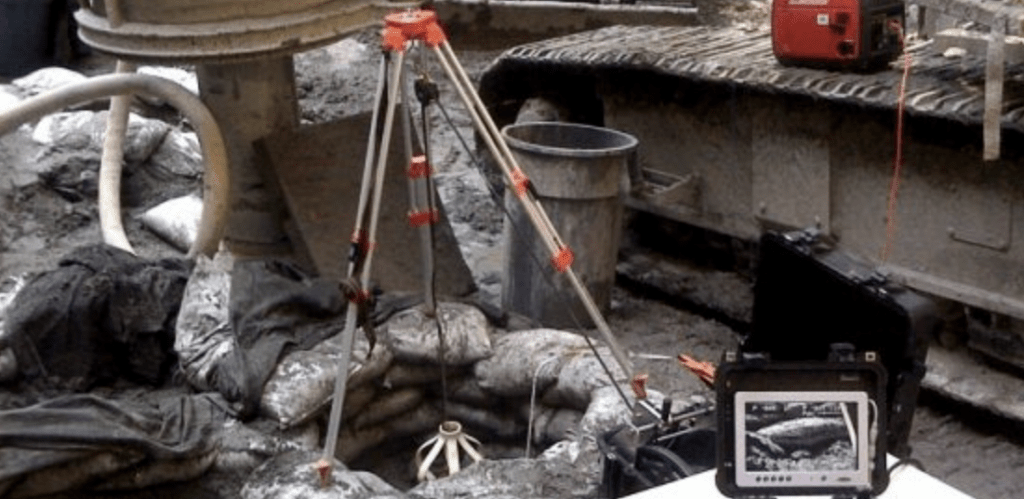 An inspection camera about to be lowered into the caisson and the laptop computer used to monitor its activity