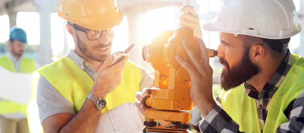 Two Saltus construction surveyors installing a total machine at a building site