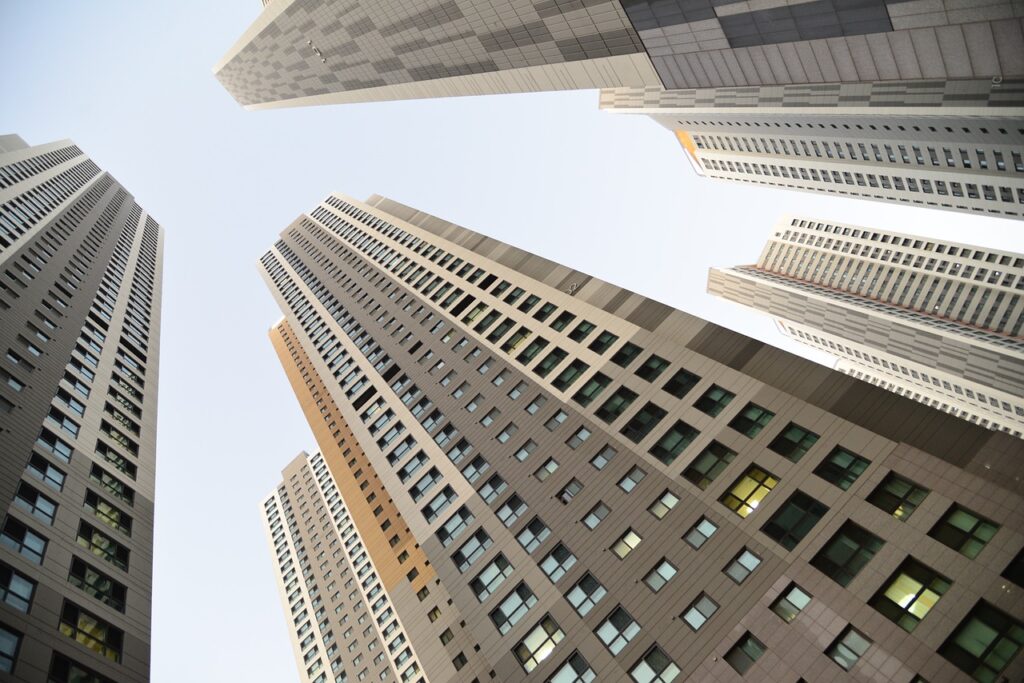 A ground-level shot looking up at four mixed-used buildings in an urban environment.